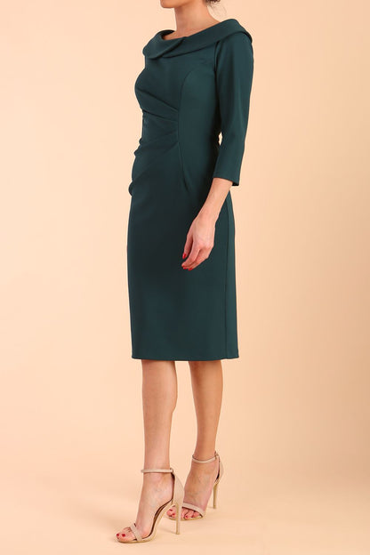Model wearing diva catwalk Monique 3/4 Sleeve Pencil Dress with Overlapping Folded Round Neckline and 3/4 sleeves and knee length in Green Gables front