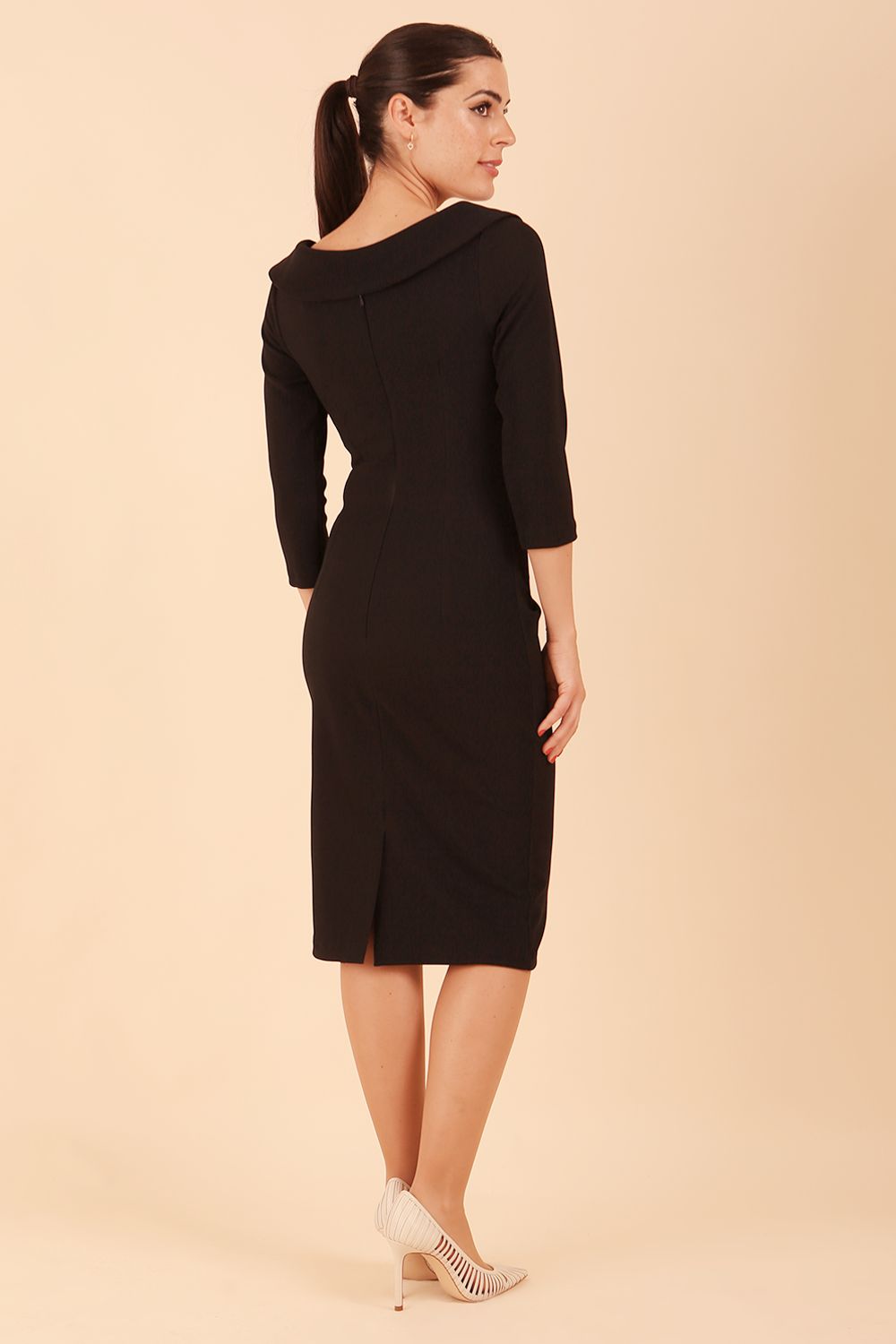 Model wearing diva catwalk Monique 3/4 Sleeve Pencil Dress with Overlapping Folded Round Neckline and 3/4 sleeves and knee length in Black front
