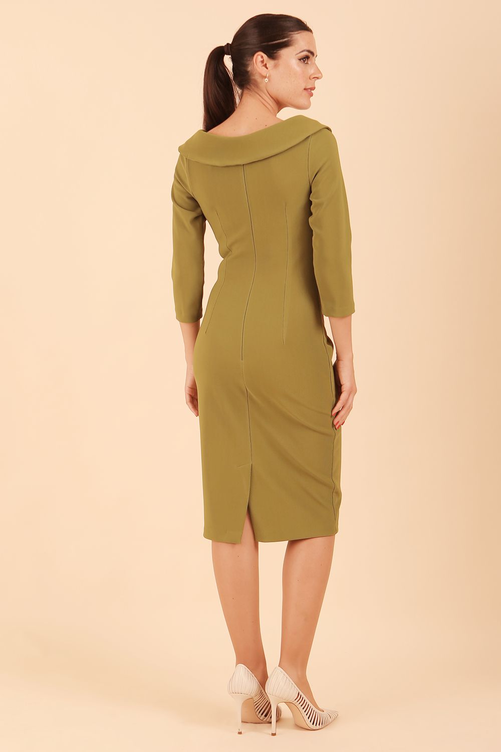 Model wearing diva catwalk Monique 3/4 Sleeve Pencil Dress with Overlapping Folded Round Neckline and 3/4 sleeves and knee length in Jasmine Green front