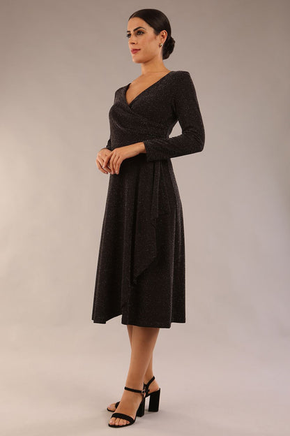 model is wearing diva catwalk westgate low v-neck wrapped swing skirt dress with long sleeves in black sparkle colour front