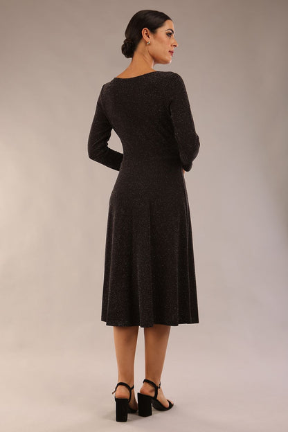 model is wearing diva catwalk westgate low v-neck wrapped swing skirt dress with long sleeves in black sparkle colour front