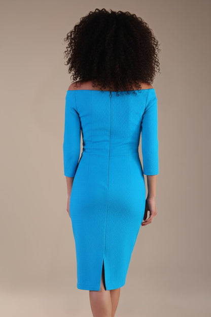 Model wearing diva catwalk Trixie dress against a beige background in (Turquoise)