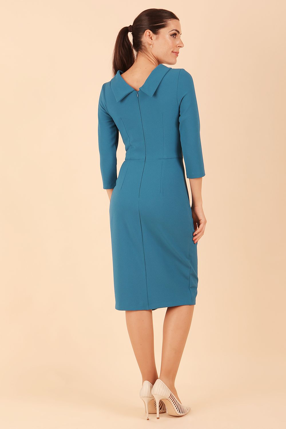 Model wearing diva catwalk Hazel pencil skirt dress with 3/4 sleeved in Tropical Teal side