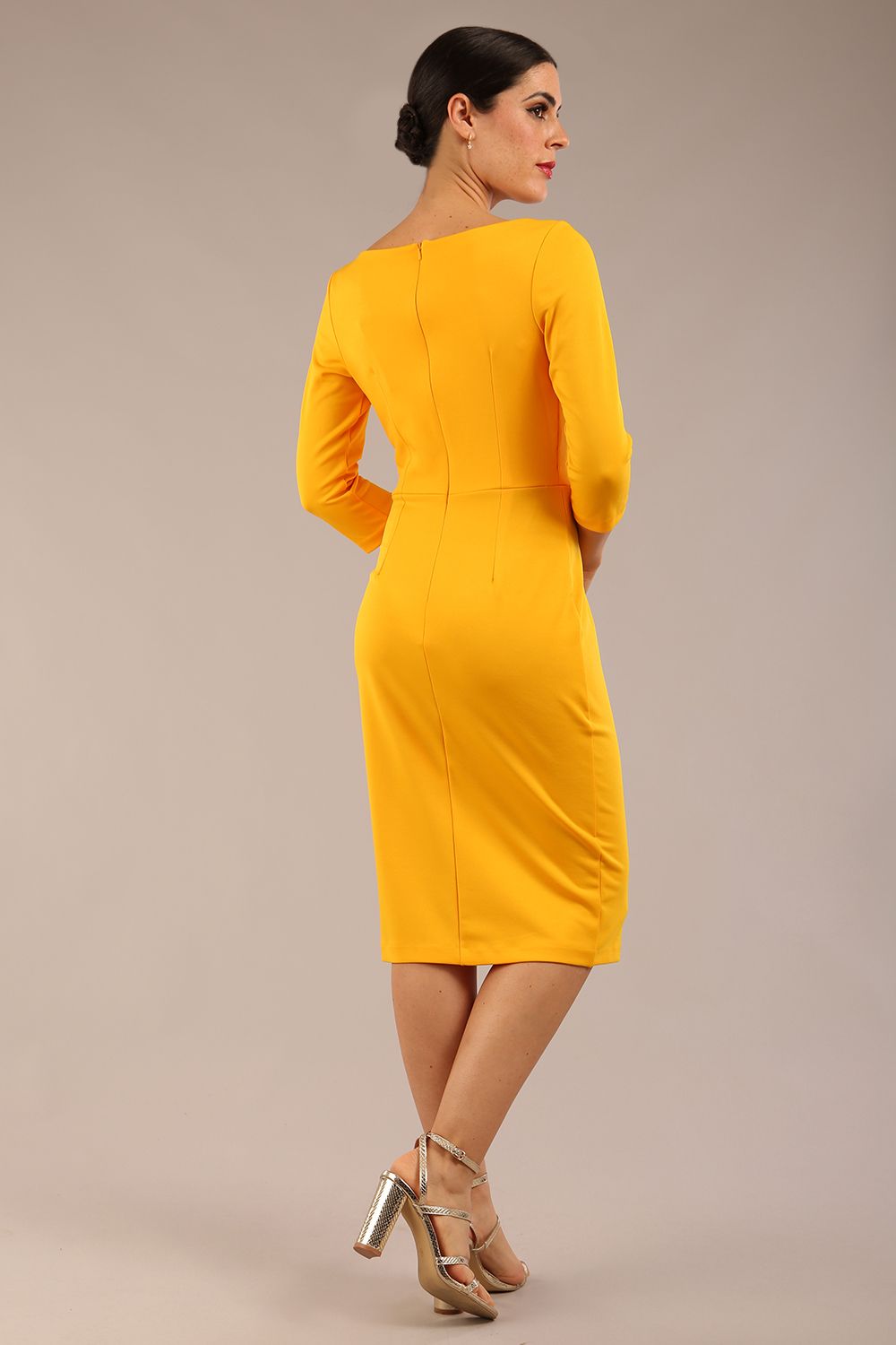 brunette Model wearing a diva catwalk Kinga 3/4 Sleeve pencil skirt dress with round neckline in Saffron Yellow colour front