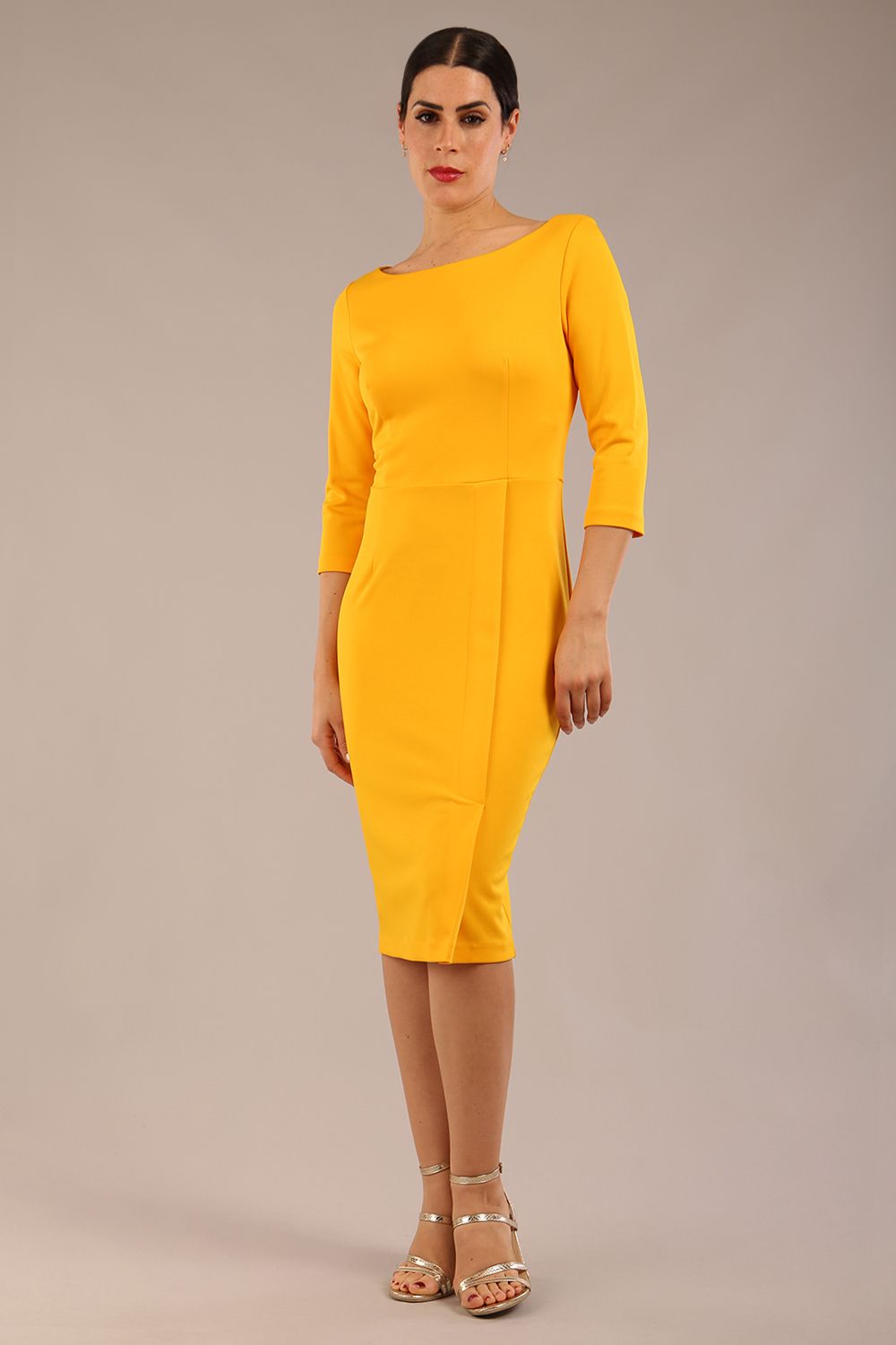 brunette Model wearing a diva catwalk Kinga 3/4 Sleeve pencil skirt dress with round neckline in Saffron Yellow colour front
