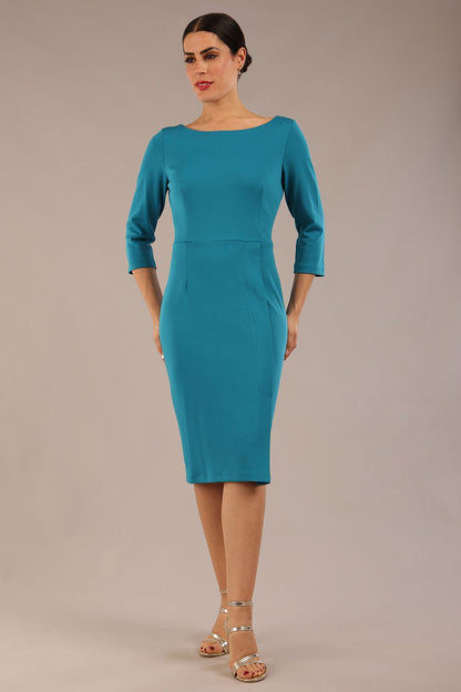 brunette Model wearing a diva catwalk Kinga 3/4 Sleeve pencil skirt dress with round neckline in Magic Blue colour front 