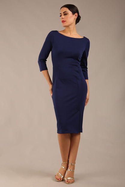 brunette Model wearing a diva catwalk Kinga 3/4 Sleeve pencil skirt dress with round neckline in Navy Blue colour front 