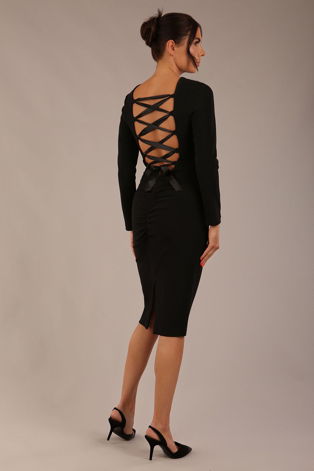 brunette model wearing a diva catwalk Zoey Sleeved Pencil Dress ribbon back with long sleeves and rushed details front and back in Black colour back close up