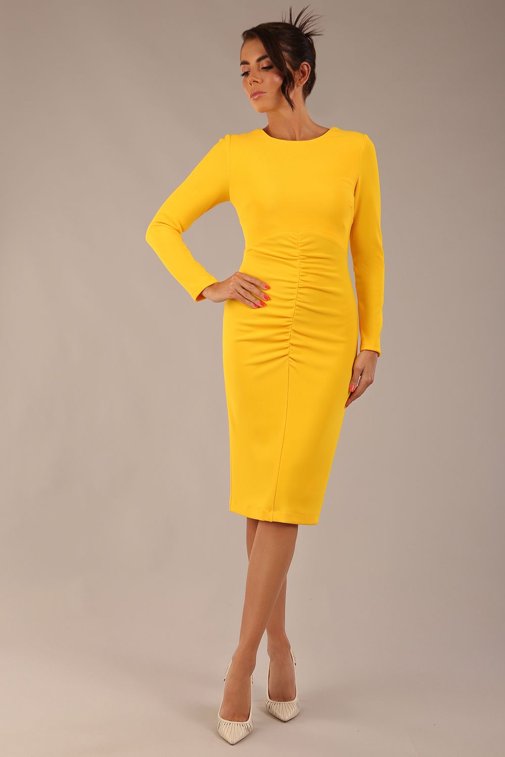 brunette model wearing a diva catwalk Zoey Sleeved Pencil Dress ribbon back with long sleeves and rushed details front and back in Sunshine Yellow colour back