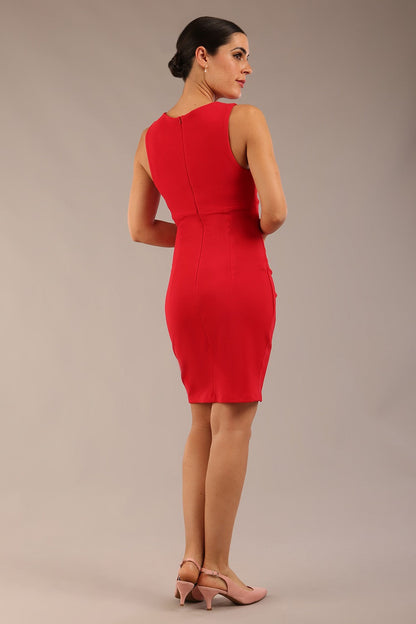 Brunette model is wearing a diva catwalk Lydia Sleeveless Mini Dress round neckline wrap style in true red colour front image 