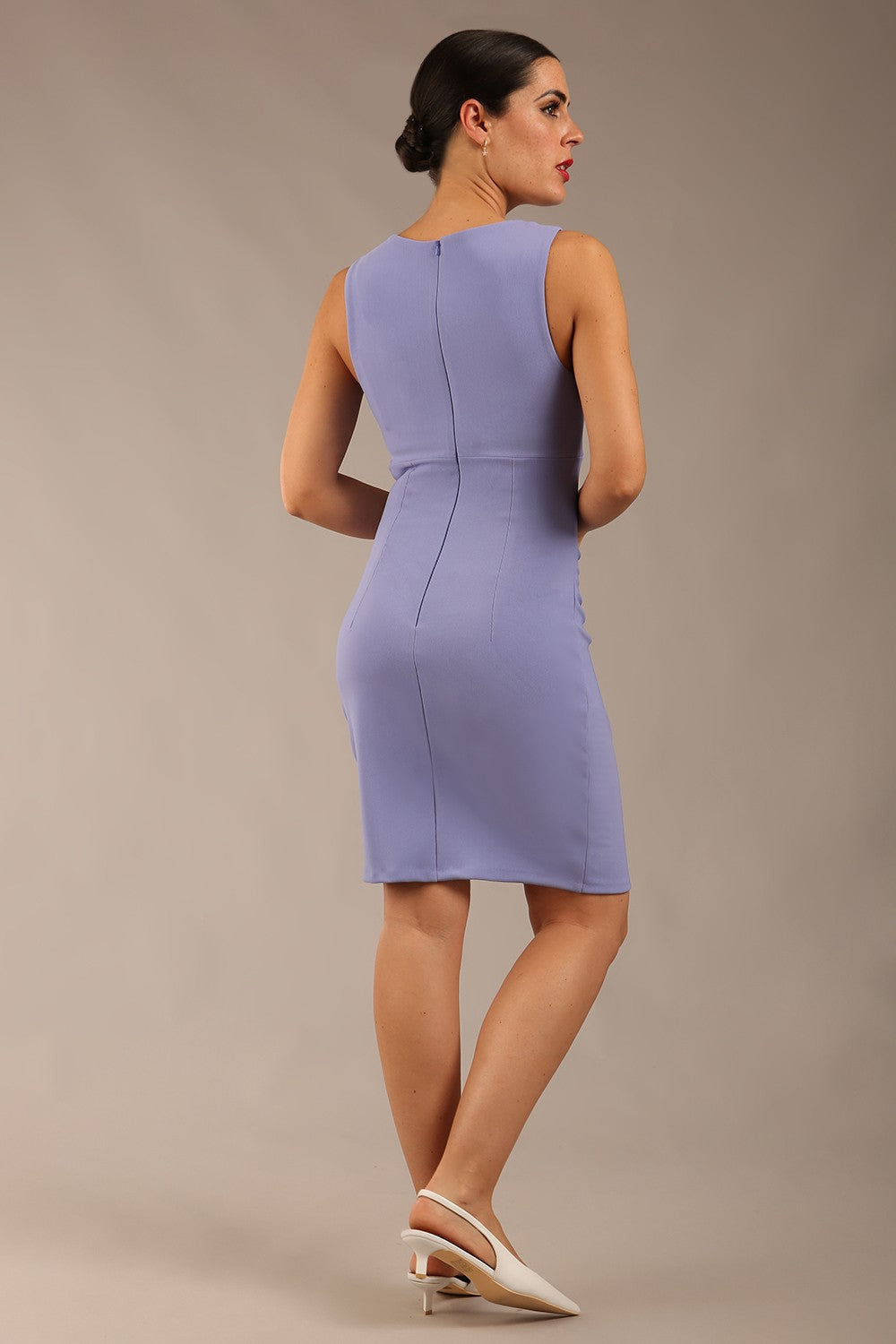 Brunette model is wearing a diva catwalk Lydia Sleeveless Mini Dress round neckline wrap style in vista blue colour front image 