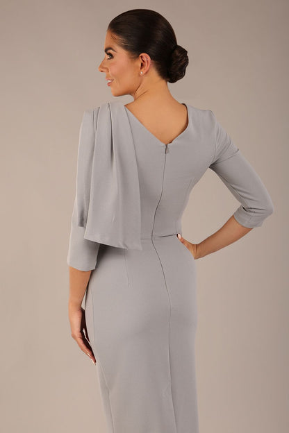 brunette model is wearing a diva catwalk Frieth Gathered Shoulder Dress 3/4 sleeves knee length with shoulder detail in dove grey colour back image
