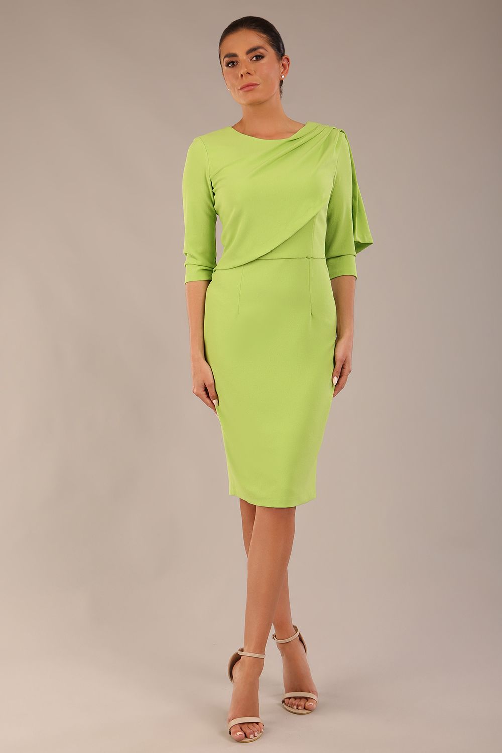 brunette model is wearing a diva catwalk Frieth Gathered Shoulder Dress 3/4 sleeves knee length with shoulder detail in paradise green colour back image close up