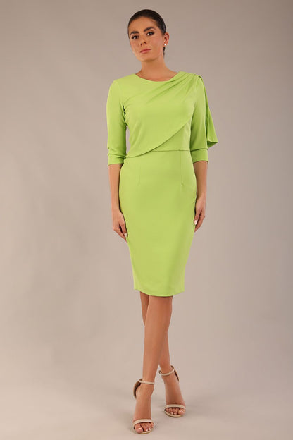 brunette model is wearing a diva catwalk Frieth Gathered Shoulder Dress 3/4 sleeves knee length with shoulder detail in paradise green colour back image close up
