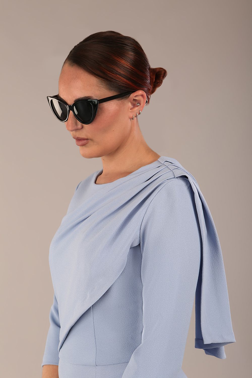 brunette model is wearing a diva catwalk Frieth Gathered Shoulder Dress 3/4 sleeves knee length with shoulder detail in powder blue colour front image