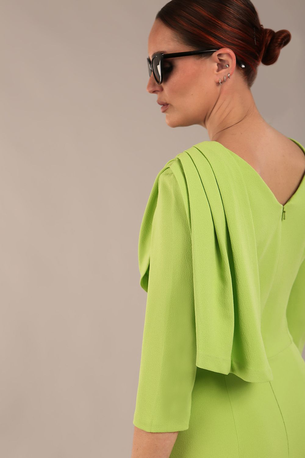 brunette model is wearing a diva catwalk Frieth Gathered Shoulder Dress 3/4 sleeves knee length with shoulder detail in paradise green colour back image close up