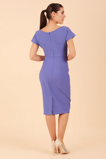 Model is wearing Brooke Cap Sleeve Pencil Dress in Couture Stretch Fabric with V Neckline and Hip Pleating in Thistle Blue back side