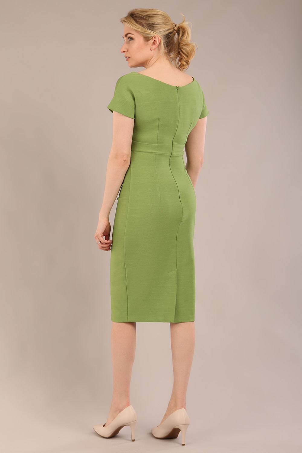 Model is wearing Brooke Cap Sleeve Pencil Dress in Couture Stretch Fabric with V Neckline and Hip Pleating in Citrus green front