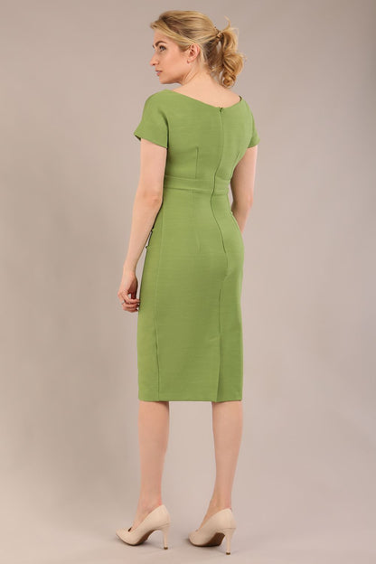Model is wearing Brooke Cap Sleeve Pencil Dress in Couture Stretch Fabric with V Neckline and Hip Pleating in Citrus green front