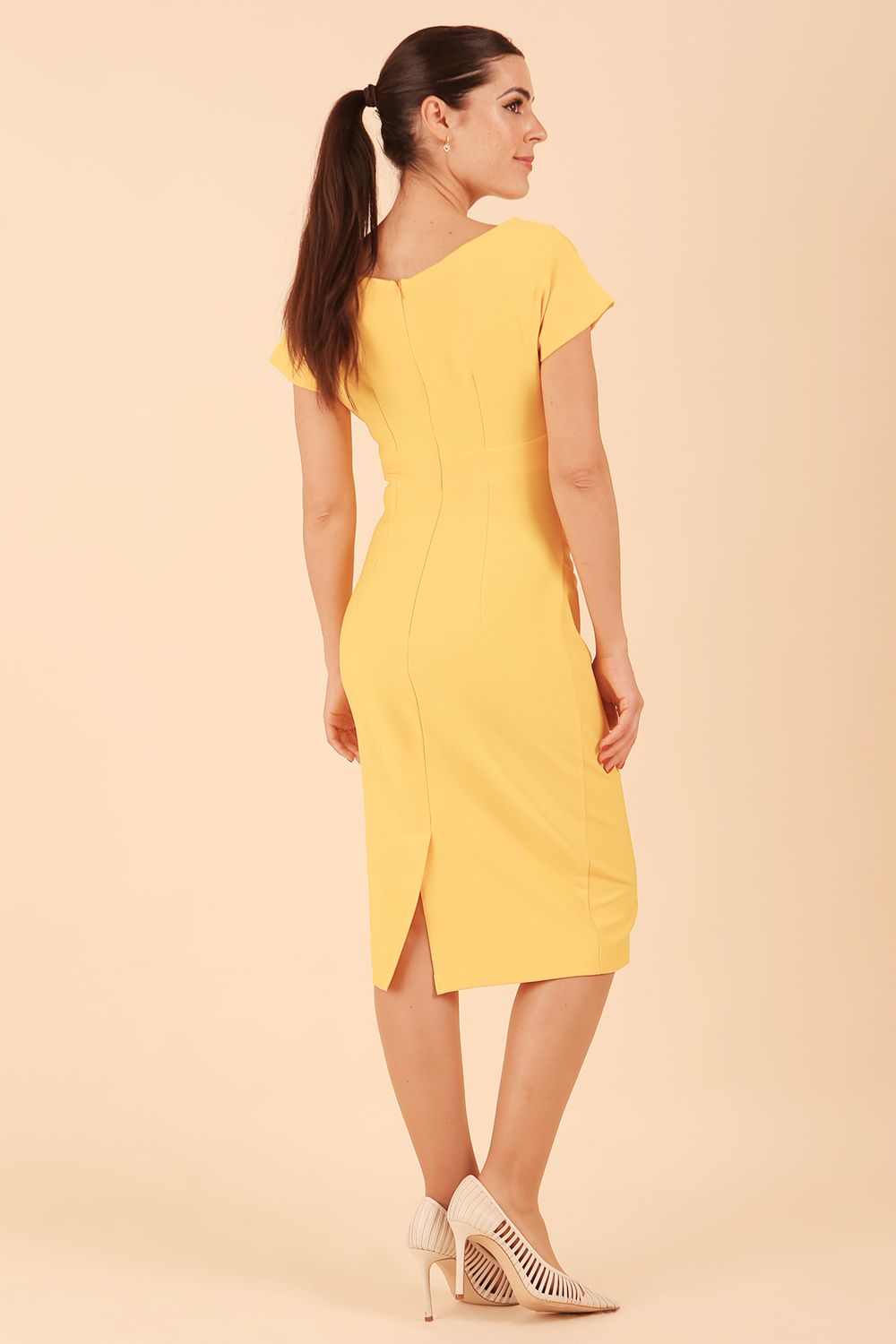 Model is wearing Brooke Cap Sleeve Pencil Dress in Couture Stretch Fabric with V Neckline and Hip Pleating in Daffodil Yellow front