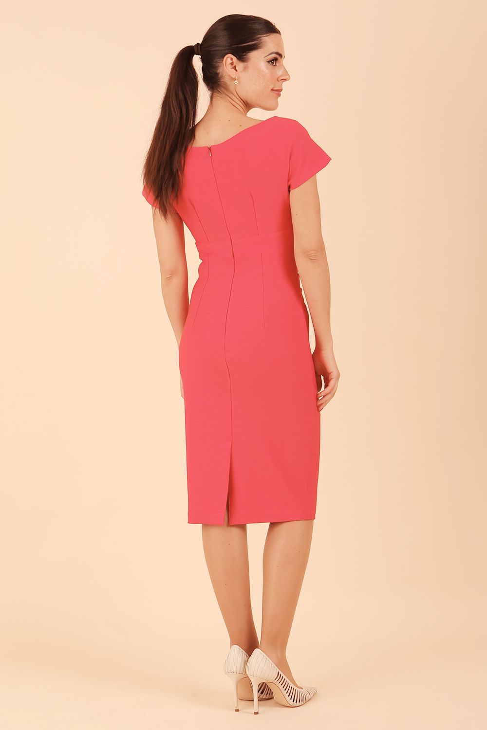 Model is wearing Brooke Cap Sleeve Pencil Dress in Couture Stretch Fabric with V Neckline and Hip Pleating in Opera Pink front