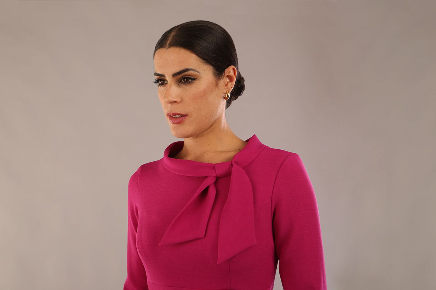 Model is wearing a diva catwalk Juliette 3/4 Sleeve Knee Length dress with bow detail in magenta front