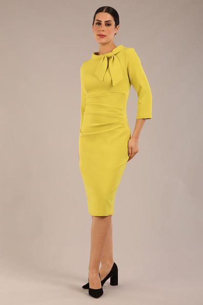 Model is wearing a diva catwalk Juliette 3/4 Sleeve Knee Length dress with bow detail in citrus green colour