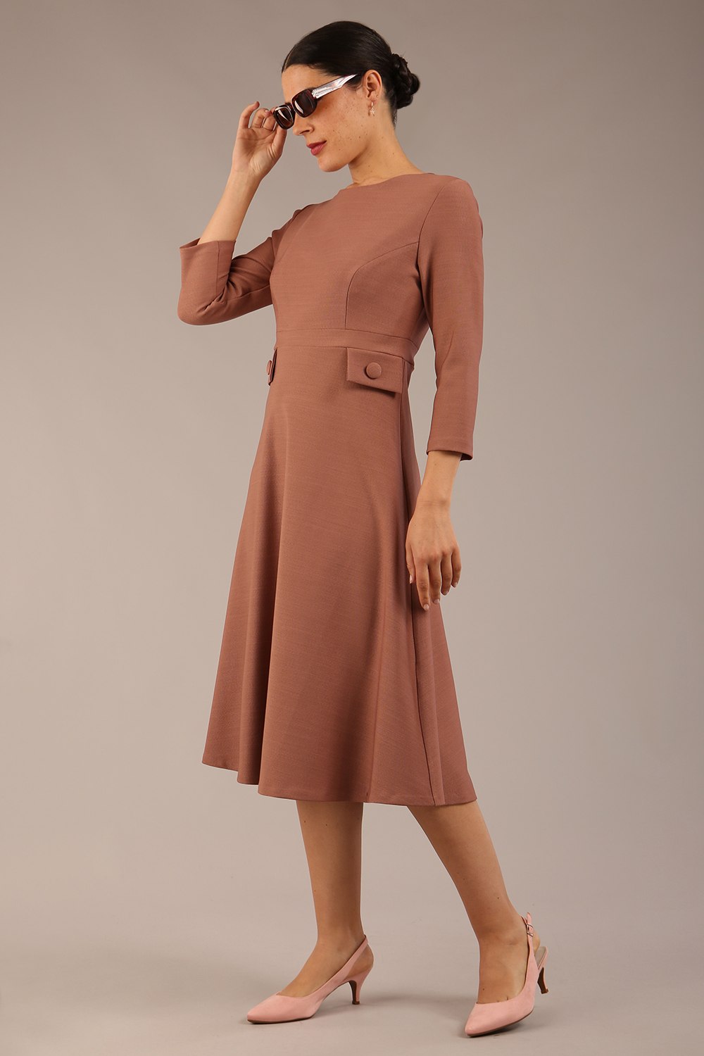 brunette Model wearing diva catwalk Gresham 3/4 Sleeve Knee Length A-Line Dress in Acorn brown colour front image with sunglasses