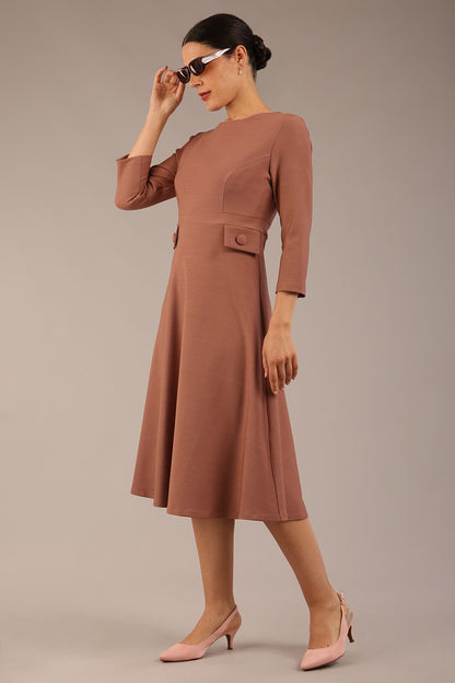 brunette Model wearing diva catwalk Gresham 3/4 Sleeve Knee Length A-Line Dress in Acorn brown colour front image with sunglasses