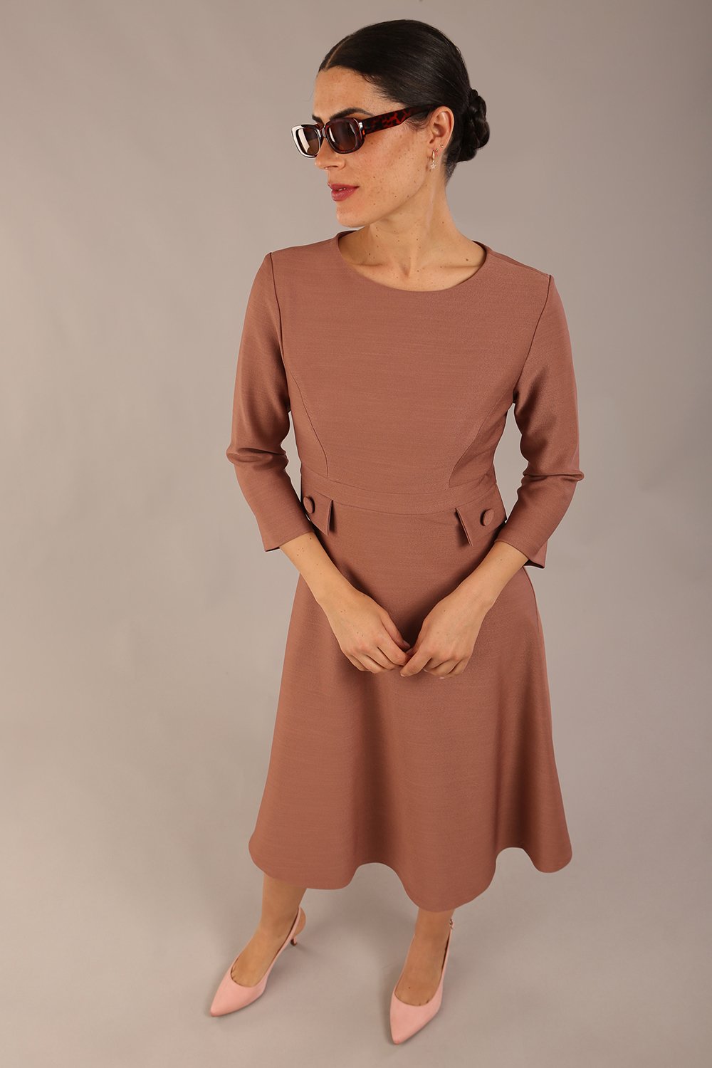 brunette Model wearing diva catwalk Gresham 3/4 Sleeve Knee Length A-Line Dress in Acorn brown colour front image with sunglasses