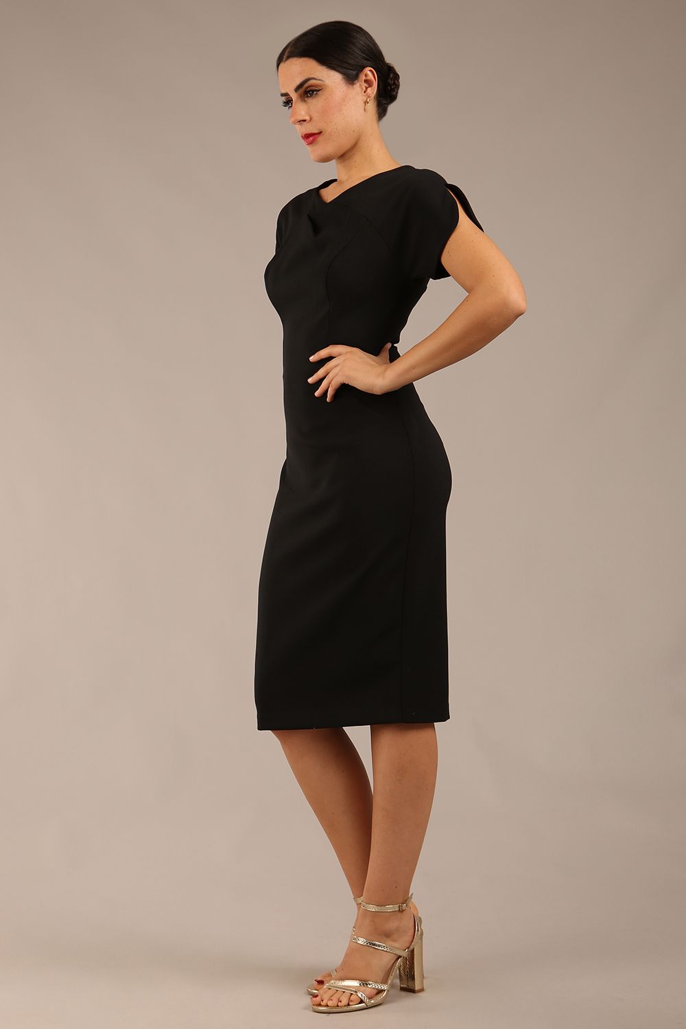 brunette Model wearing a diva catwalk Sheena Short Sleeve with an open split Knee Length Pencil Dress with Diamond Neckline in Black colour back