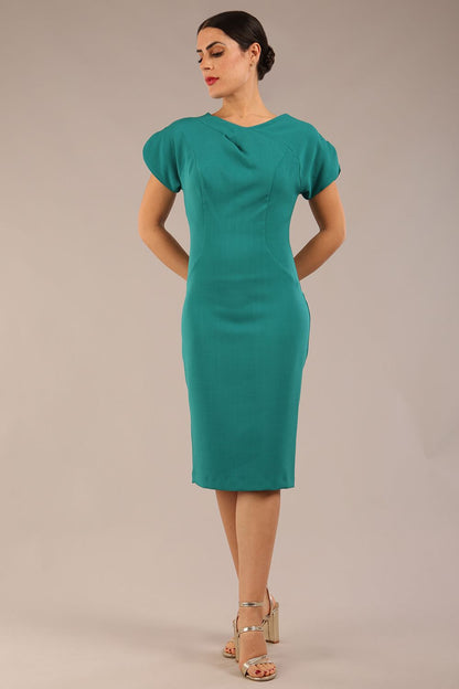 brunette Model wearing a diva catwalk Sheena Short Sleeve with an open split Knee Length Pencil Dress with Diamond Neckline in Parasailing Green colour front
