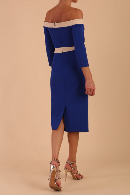 Model wearing a diva catwalk Brittany Off Shoulder Bow detail Pencil Dress with 3/4 sleeves and knee length in Cobalt Blue and Sandshell Beige colour front side detail