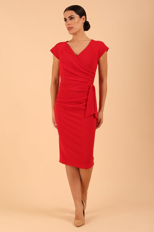 Model wearing diva catwalk Syon Short Sleeved Pencil Dress with tie detail at the waist area in True red colour front 