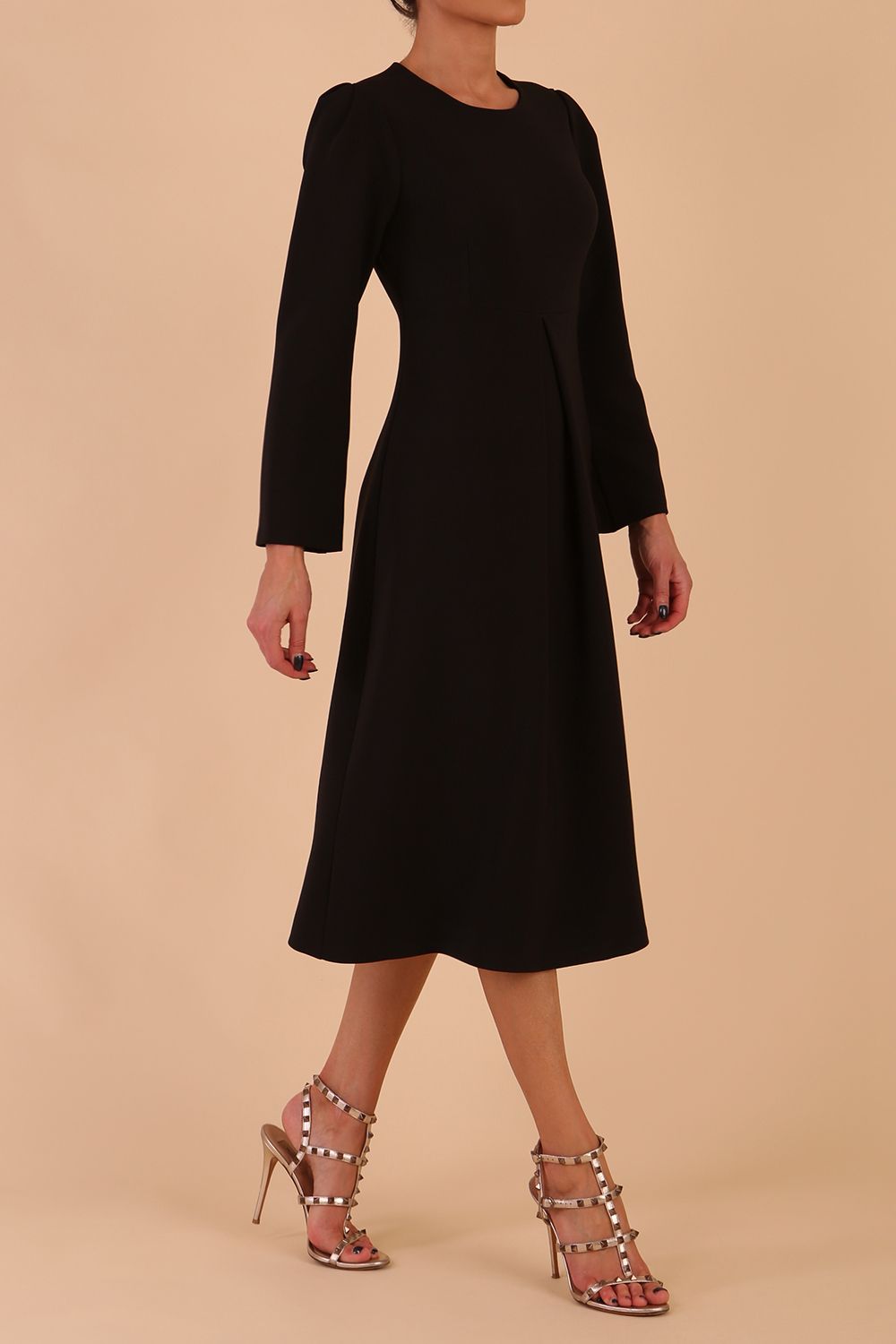 Model wearing diva catwalk in Bombay fabric the Epsom Long Sleeve and round neckline and midi A-Line Dress in Black colour front side (Black)