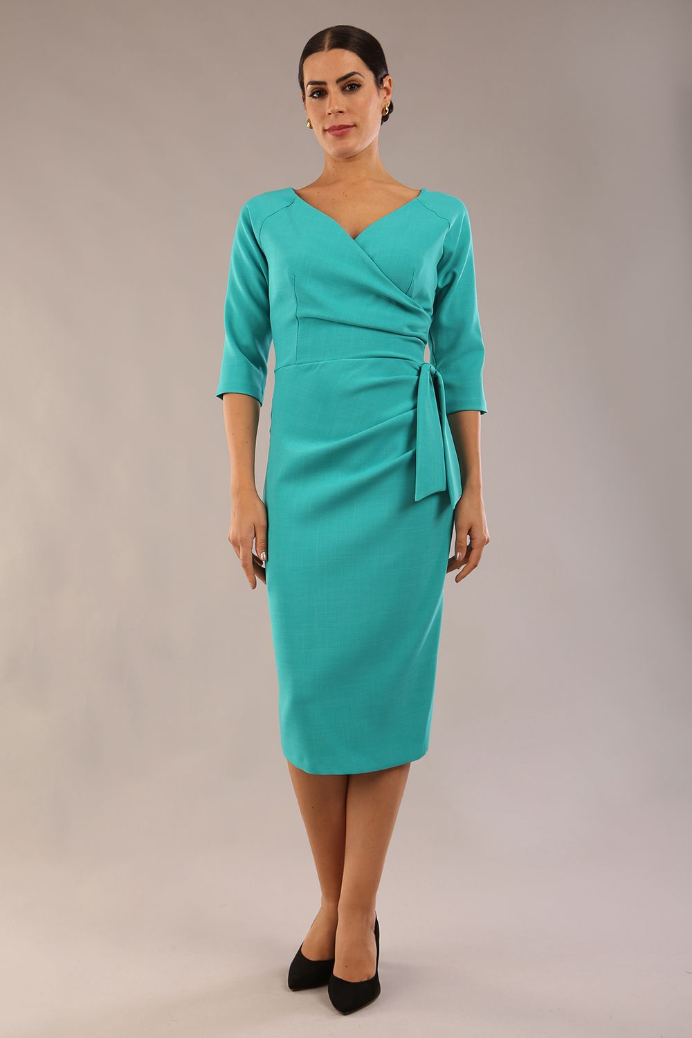 model is wearing a diva catwalk Bronwen 3/4 sleeved Tie Pencil Dress in aqua green colour side front