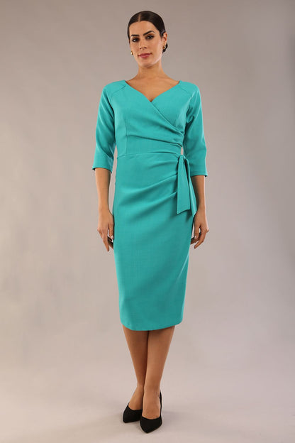 model is wearing a diva catwalk Bronwen 3/4 sleeved Tie Pencil Dress in aqua green colour side front