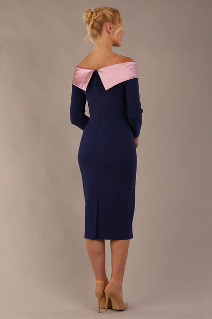 Model is wearing a diva catwalk Rosalind Off Shoulder Bow Detail Pencil Dress 3/4 sleeve in Navy Blue/Lilac Contrast contrast front image (Navy Blue / Lilac Contrast)