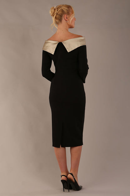 brunette Model is wearing a diva catwalk Rosalind Off Shoulder Bow Detail Pencil Dress 3/4 sleeve in Black/Champagne contrast front image (Black / Champagne Contrast)