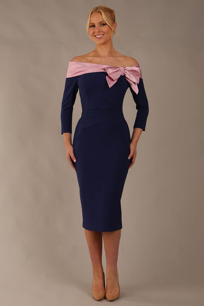 Model is wearing a diva catwalk Rosalind Off Shoulder Bow Detail Pencil Dress 3/4 sleeve in Navy Blue/Lilac Contrast contrast front image (Navy Blue / Lilac Contrast)