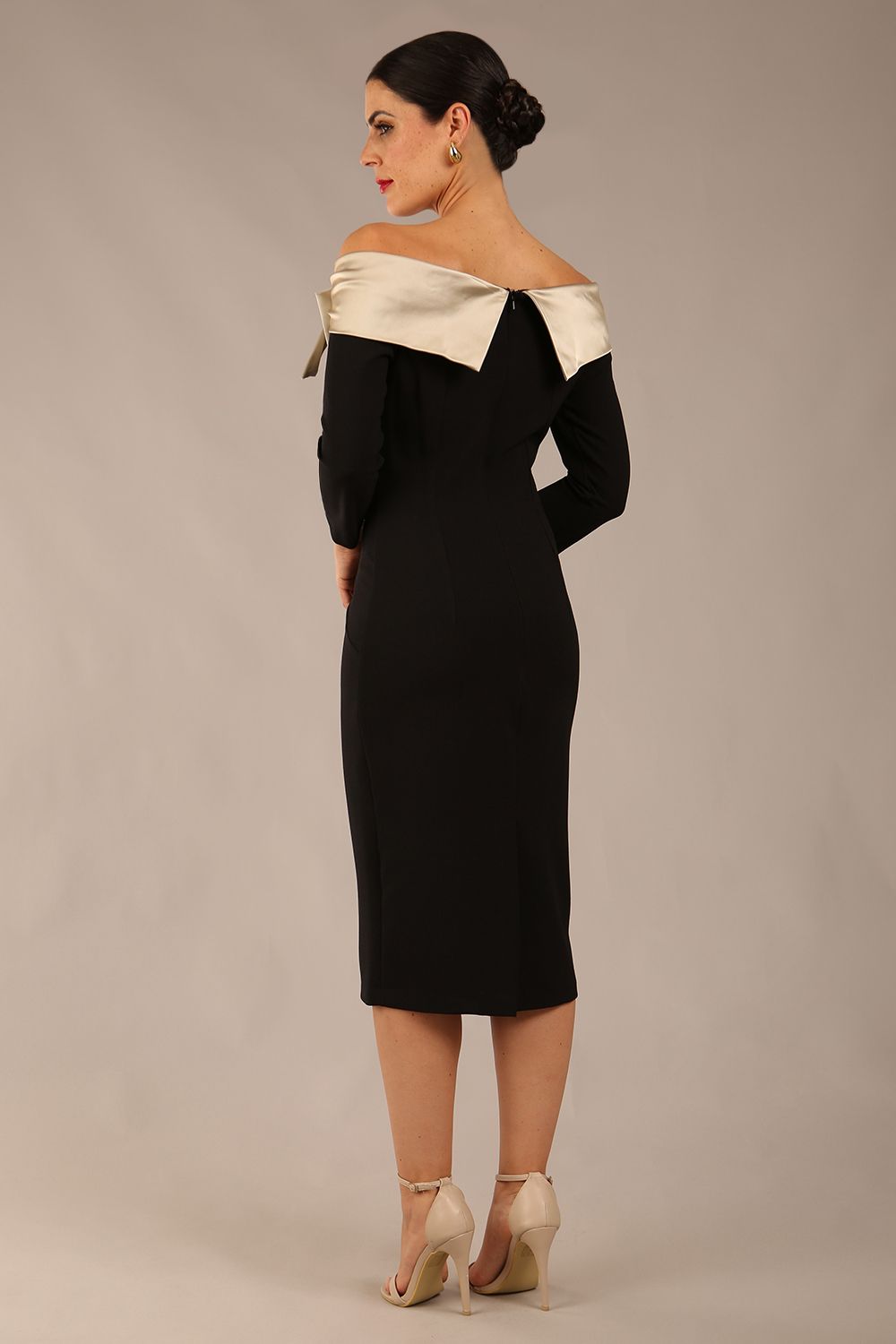 brunette Model is wearing a diva catwalk Rosalind Off Shoulder Bow Detail Pencil Dress 3/4 sleeve in Black/Champagne contrast front image (Black / Champagne Contrast)