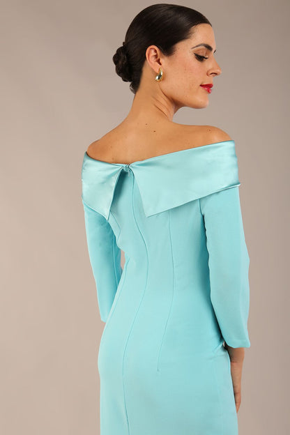 Model is wearing a diva catwalk Rosalind Off Shoulder Bow Detail Pencil Dress 3/4 sleeve in Turquoise contrast front image (Turquoise)