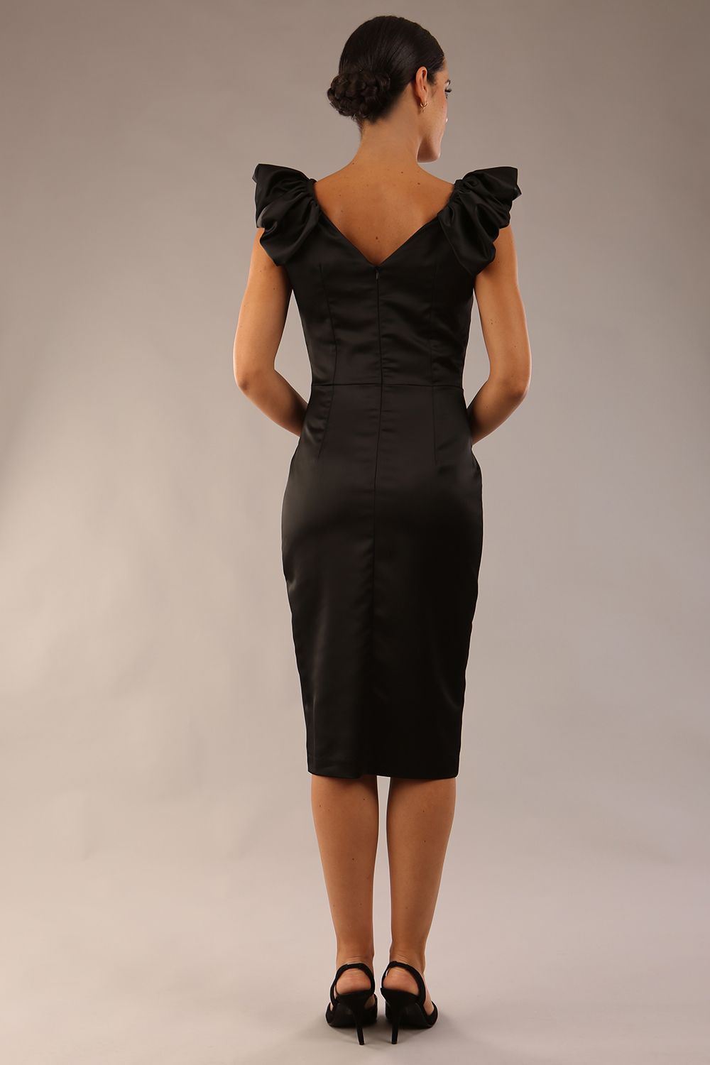 model is wearing a diva catwalk Prudence Satin Pencil Dress sleeveless and knee length with front vent in black colour (Black)
