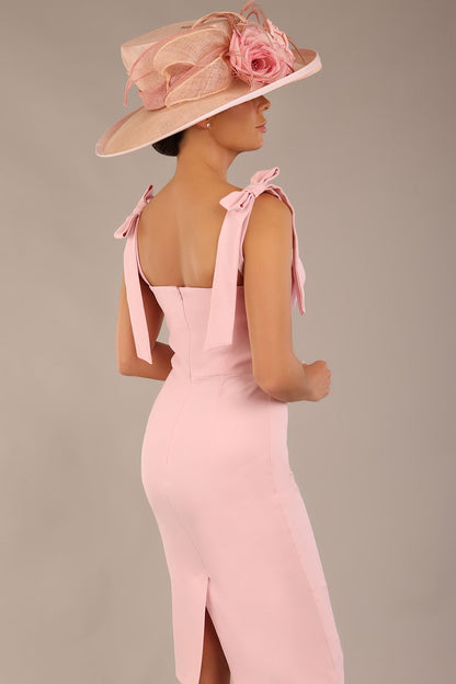 brunette model wearing a diva catwalk Philippa Pencil Wiggle Dress sleeveless style, tie detail on the shoulders knee length and sweetheart neckline in crystal pink colour front 