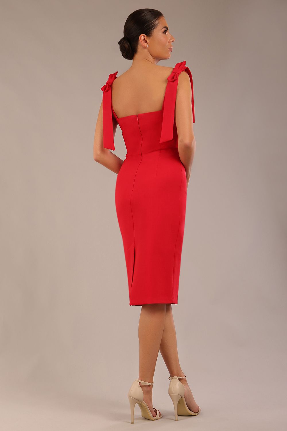 brunette model wearing a diva catwalk Philippa Pencil Wiggle Dress sleeveless style, tie detail on the shoulders knee length and sweetheart neckline in scarlet red colour front 