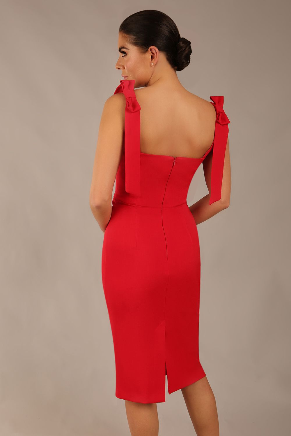 brunette model wearing a diva catwalk Philippa Pencil Wiggle Dress sleeveless style, tie detail on the shoulders knee length and sweetheart neckline in scarlet red colour front 