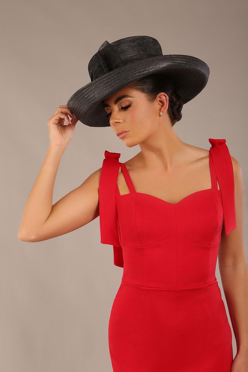 brunette model wearing a diva catwalk Philippa Pencil Wiggle Dress sleeveless style, tie detail on the shoulders knee length and sweetheart neckline in scarlet red colour front 