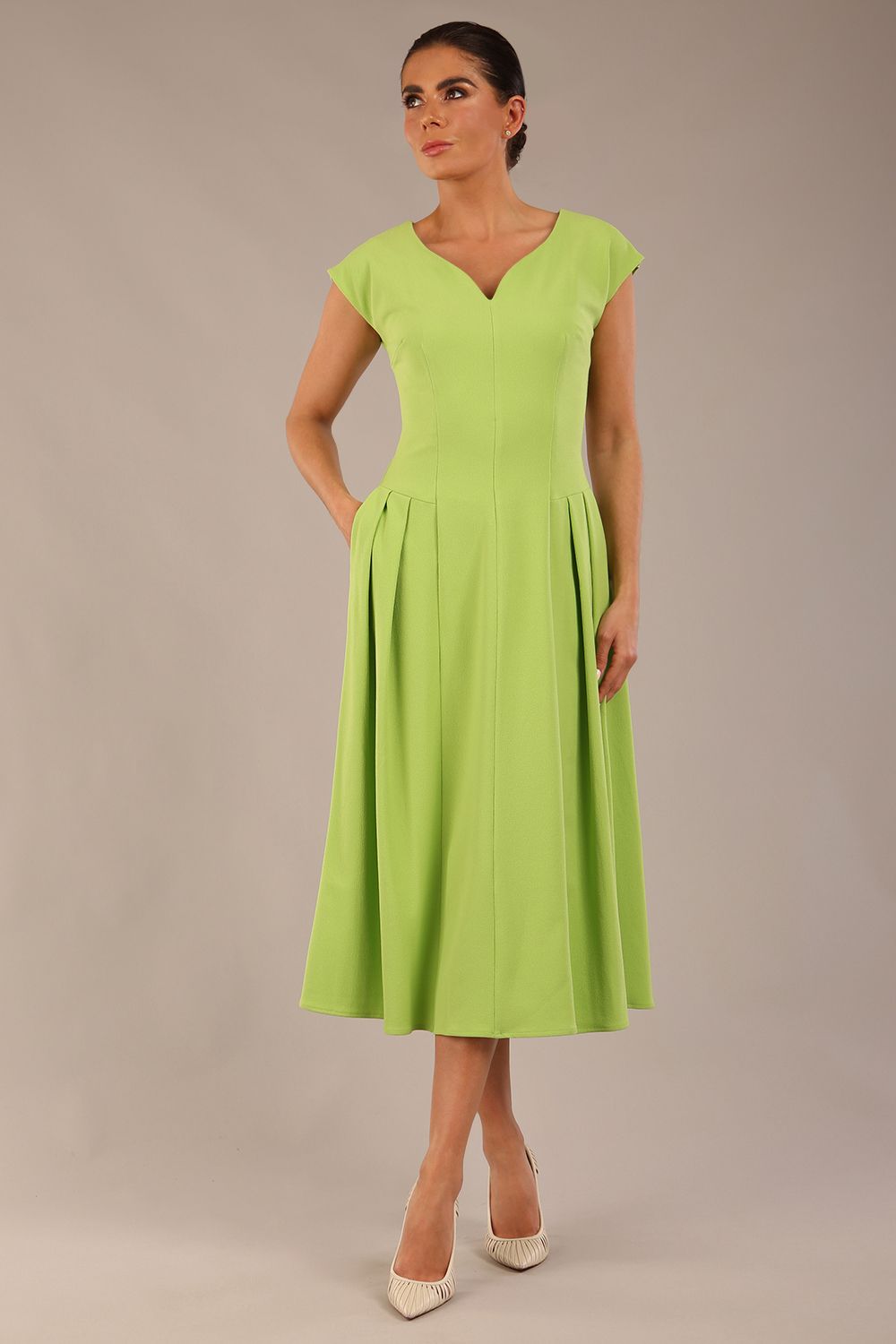 brunette model is wearing a diva catwalk Audrey a-line Dress sweetheart neckline and With Pockets and sleeveless with ankle length in lime green colour