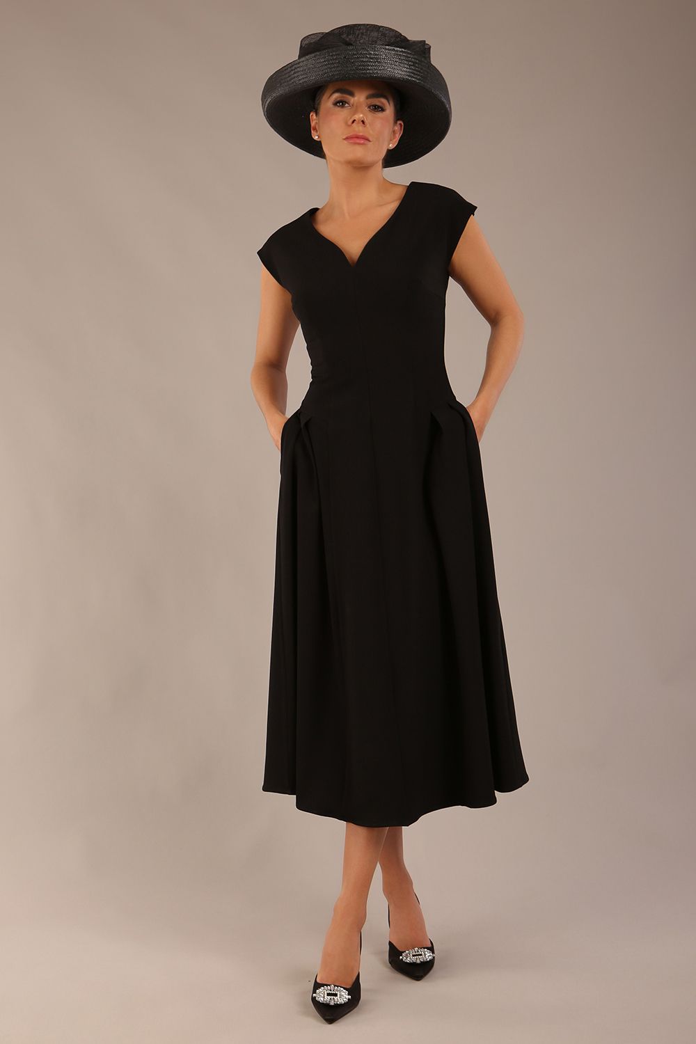 brunette model is wearing a diva catwalk Audrey a-line Dress sweetheart neckline and With Pockets and sleeveless with ankle length black colour back