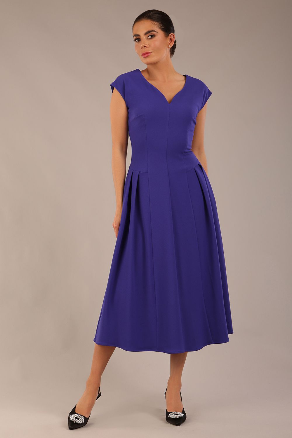brunette model is wearing a diva catwalk Audrey a-line Dress sweetheart neckline and With Pockets and sleeveless with ankle length in spectrum indigo colour back